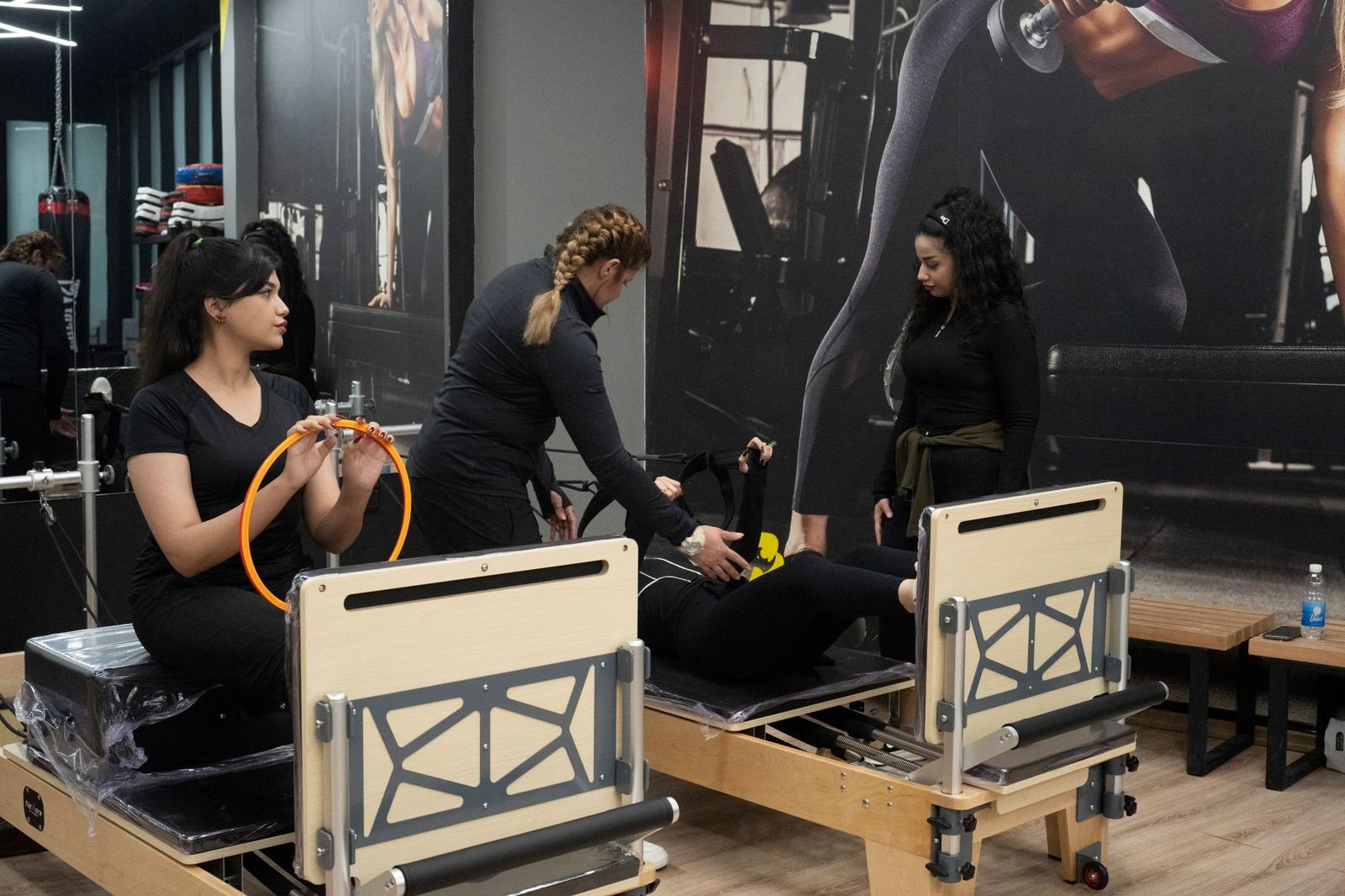 Women Practicing Pilates in Modern Studio