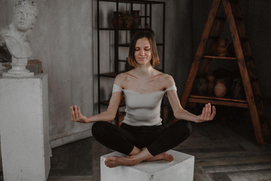 Woman Sitting Cross Legged in Art Studio
