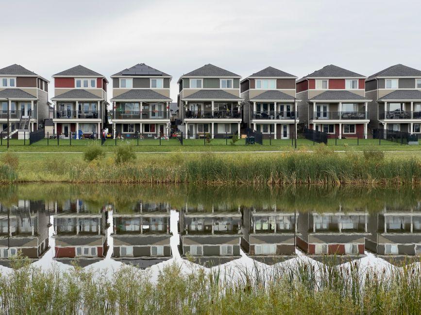 Modern Row of Houses Reflected in Water