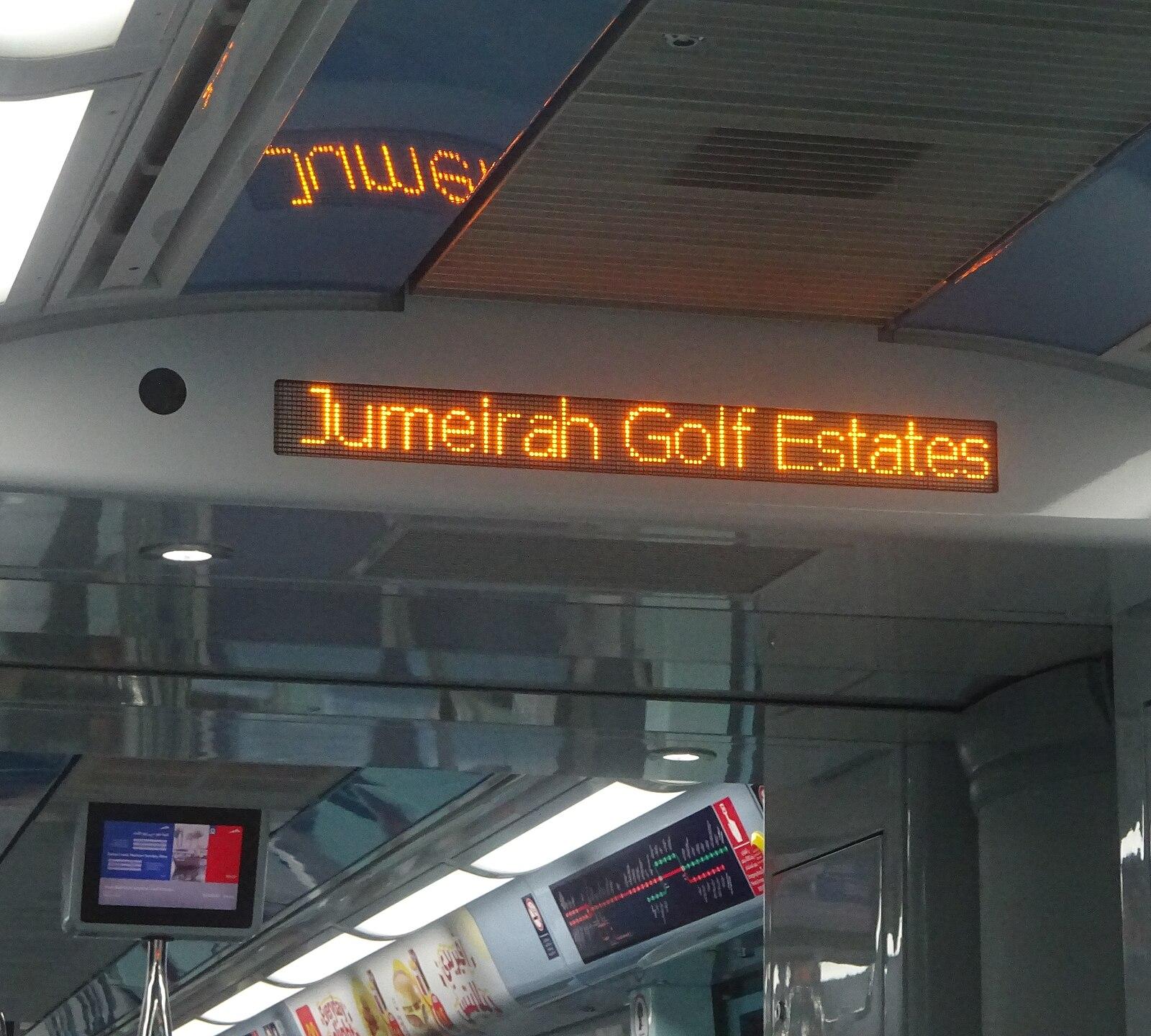 Jumeirah Golf Estates sign on metro line train